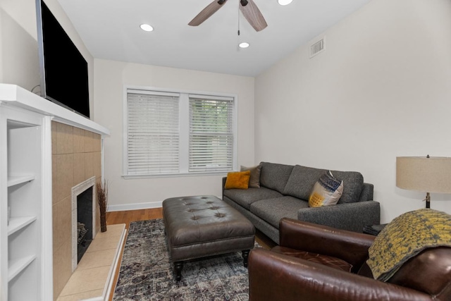 555 Elmwood Ave Unit 1, Evanston, IL 60202 - living area with a ceiling fan, a tiled fireplace, wood finished floors, recessed lighting, and built in shelves