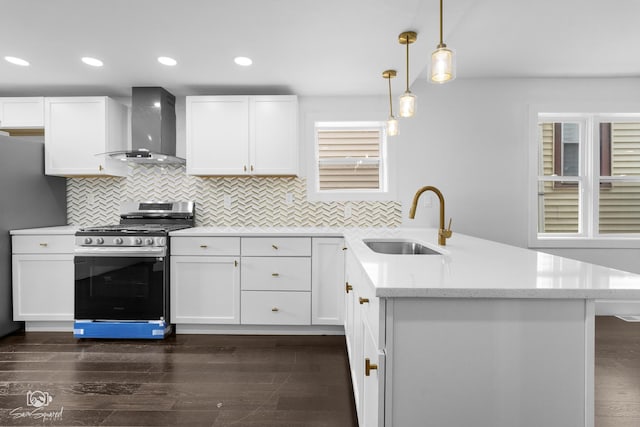 7227 S Paulina St, Chicago, IL 60636 - kitchen featuring wall chimney exhaust hood, appliances with stainless steel finishes, a peninsula, white cabinets, and backsplash