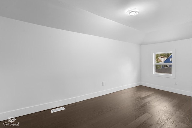 7227 S Paulina St, Chicago, IL 60636 - empty room with dark wood-style floors and vaulted ceiling