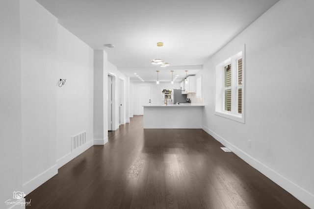 7227 S Paulina St, Chicago, IL 60636 - unfurnished living room with dark wood finished floors and baseboards