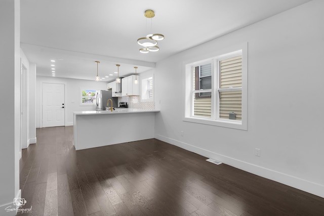7227 S Paulina St, Chicago, IL 60636 - unfurnished living room with dark wood-style floors and a chandelier