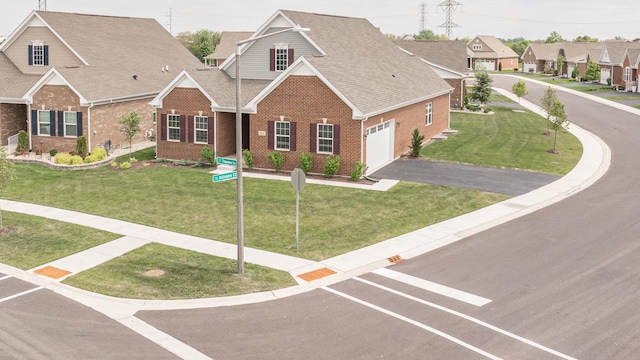 2107 Traemore Ln, New Lenox, IL 60451 - view of front of home featuring brick siding, a garage, asphalt driveway, and a front yard