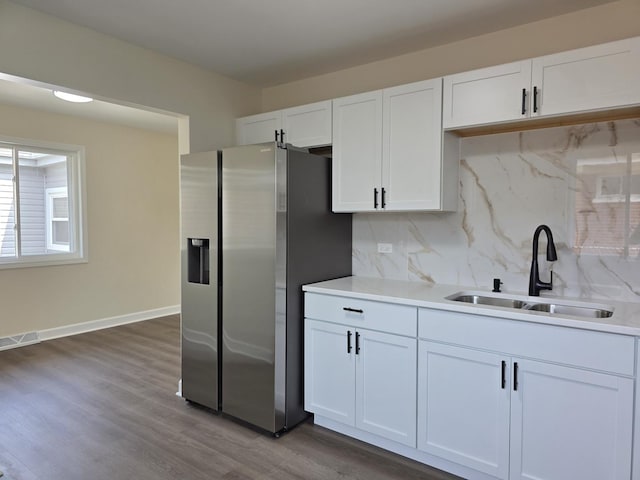 1449 Kristan Ave, North Chicago, IL 60064 - kitchen featuring stainless steel refrigerator with ice dispenser, backsplash, white cabinetry, and light countertops