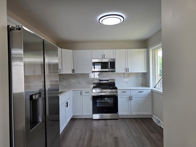 1449 Kristan Ave, North Chicago, IL 60064 - kitchen featuring stainless steel appliances, white cabinetry, and dark wood-style floors