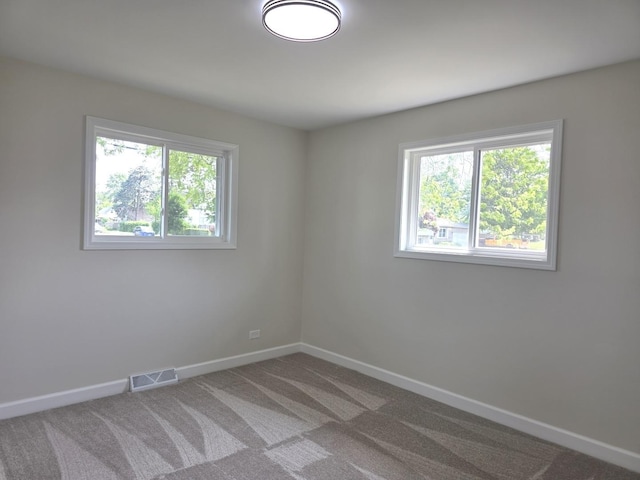 1449 Kristan Ave, North Chicago, IL 60064 - carpeted empty room with healthy amount of natural light