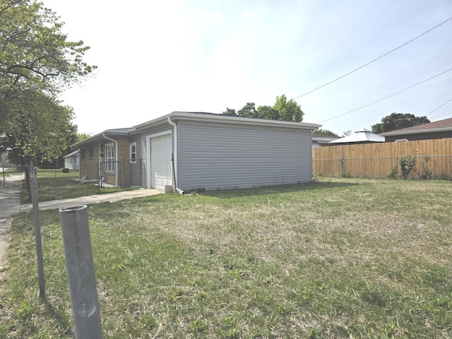 1449 Kristan Ave, North Chicago, IL 60064 - view of yard with an attached garage and concrete driveway