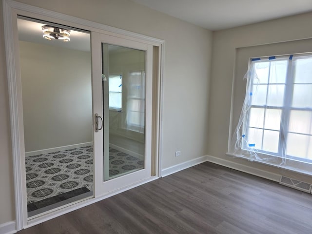 1449 Kristan Ave, North Chicago, IL 60064 - unfurnished room with dark wood-style flooring and baseboards