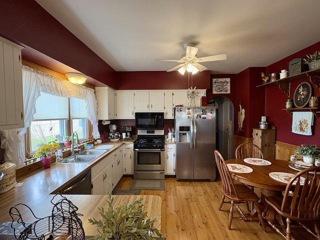 1112 W Wilmington-Peotone Rd, Peotone, IL 60468 - kitchen featuring stainless steel appliances, a ceiling fan, light wood finished floors, arched walkways, and light countertops