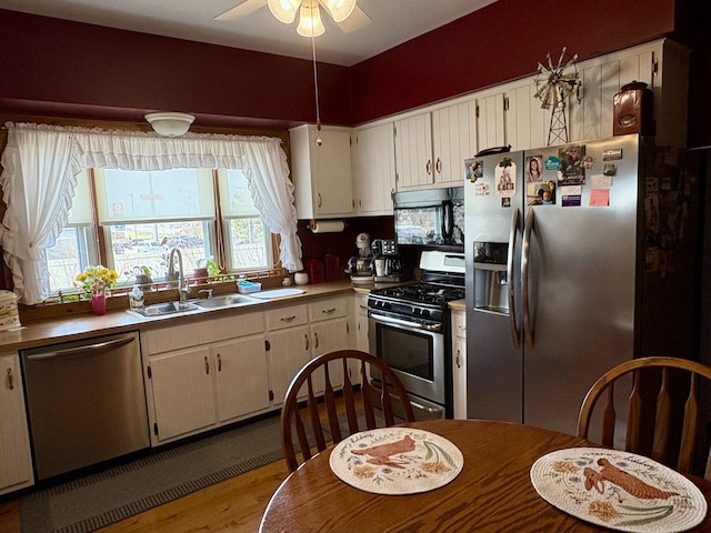 1112 W Wilmington-Peotone Rd, Peotone, IL 60468 - kitchen with stainless steel appliances, ceiling fan, light wood-type flooring, white cabinetry, and light countertops