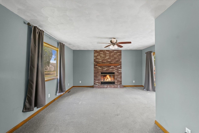 103 S Locust St, Loda, IL 60948 - unfurnished living room with a ceiling fan, carpet flooring, and a fireplace