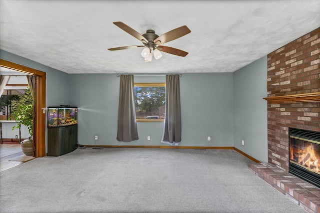 103 S Locust St, Loda, IL 60948 - unfurnished living room with plenty of natural light, carpet floors, a fireplace, and a ceiling fan