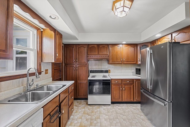 103 S Locust St, Loda, IL 60948 - kitchen featuring white appliances, under cabinet range hood, light countertops, brown cabinets, and recessed lighting