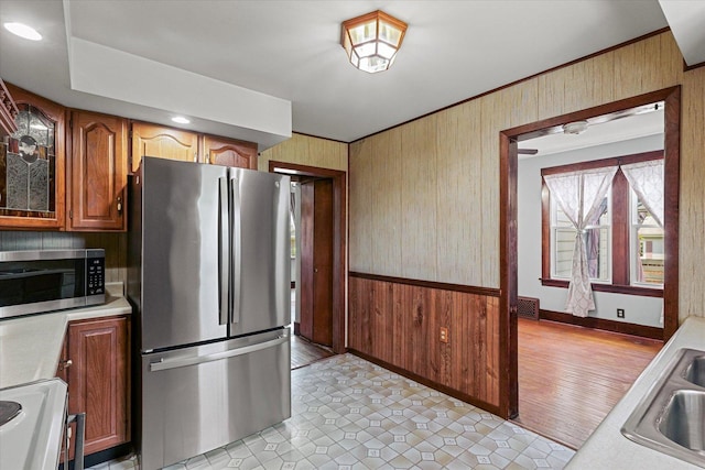 103 S Locust St, Loda, IL 60948 - kitchen featuring stainless steel appliances, wooden walls, and light countertops