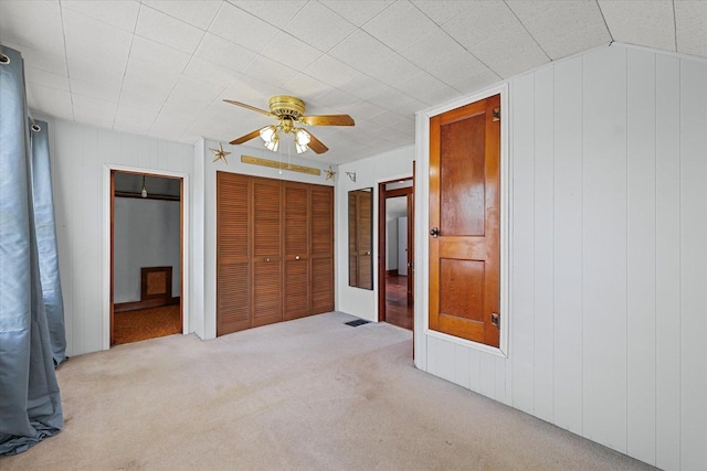 103 S Locust St, Loda, IL 60948 - unfurnished bedroom with carpet floors, a ceiling fan, and wooden walls