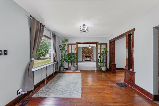 103 S Locust St, Loda, IL 60948 - foyer featuring wood finished floors and a brick fireplace