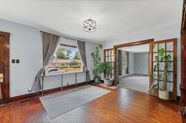 103 S Locust St, Loda, IL 60948 - foyer entrance with wood-type flooring and a chandelier