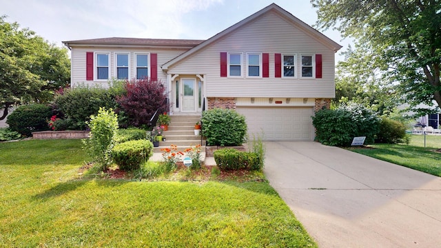 1005 N Dovington Dr, Hoffman Estates, IL 60169 - view of front of home with an attached garage, concrete driveway, brick siding, and a front lawn