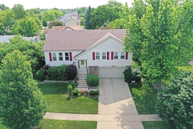 1005 N Dovington Dr, Hoffman Estates, IL 60169 - split foyer home featuring a garage, driveway, and a front yard