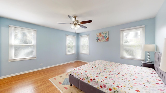 1005 N Dovington Dr, Hoffman Estates, IL 60169 - bedroom featuring multiple windows, wood finished floors, and ceiling fan