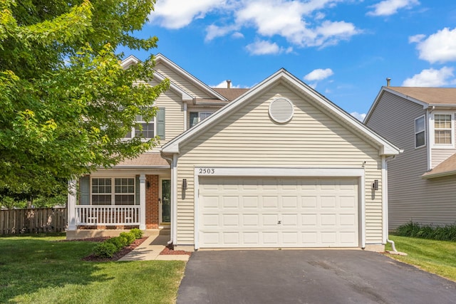 2503 Red Hawk Ridge Ct, Aurora, IL 60503 - traditional-style house with asphalt driveway, a garage, a front lawn, and a porch