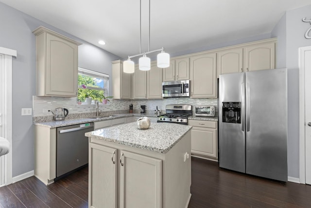 2503 Red Hawk Ridge Ct, Aurora, IL 60503 - kitchen with appliances with stainless steel finishes, cream cabinets, dark wood-style floors, backsplash, and a kitchen island