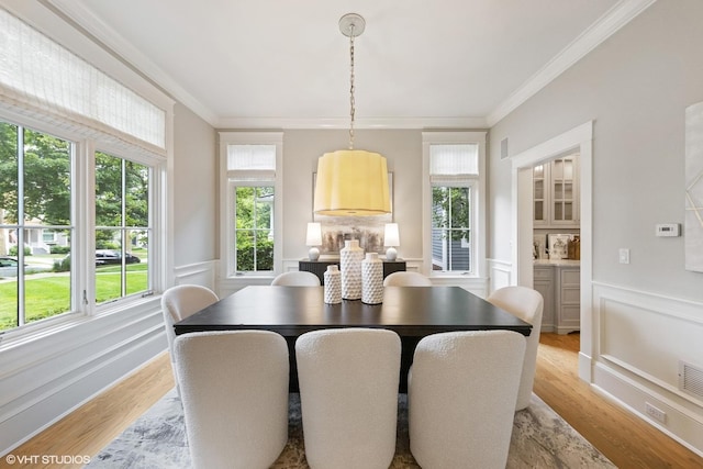606 S Washington St, Hinsdale, IL 60521 - dining room with ornamental molding, light wood-style flooring, a decorative wall, and a wainscoted wall