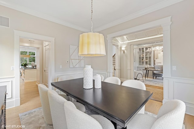 606 S Washington St, Hinsdale, IL 60521 - dining room featuring a decorative wall, crown molding, wainscoting, and light wood-style floors