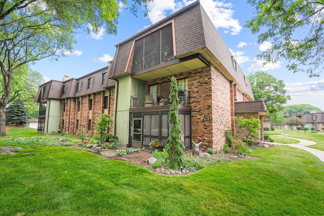 9197 N Rd Unit C, Palos Hills, IL 60465 - back of house with a yard, brick siding, and a balcony