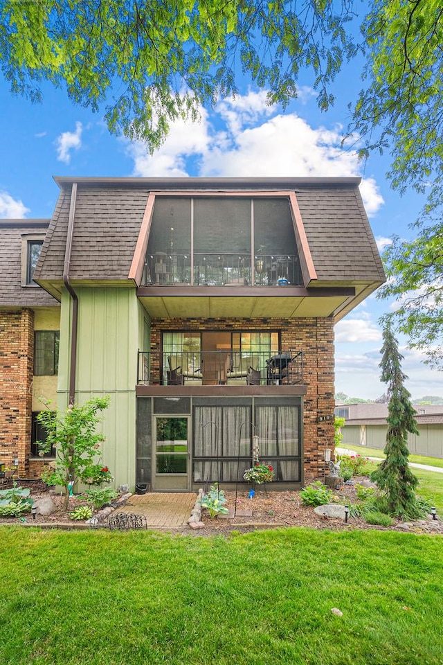 9197 N Rd Unit C, Palos Hills, IL 60465 - rear view of property featuring a yard, a balcony, and a sunroom