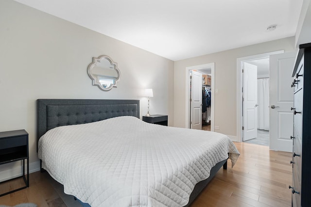 9197 N Rd Unit C, Palos Hills, IL 60465 - bedroom featuring a walk in closet, wood finished floors, and a closet