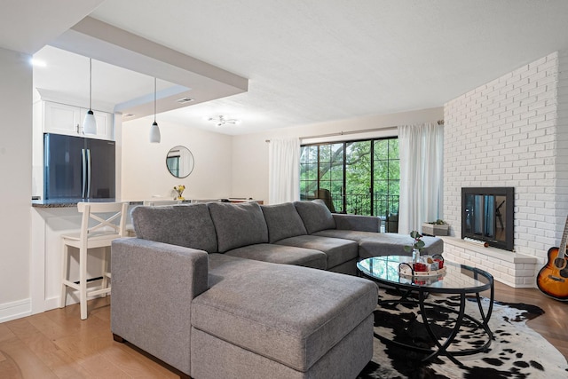 9197 N Rd Unit C, Palos Hills, IL 60465 - living area with light wood-style floors and a brick fireplace