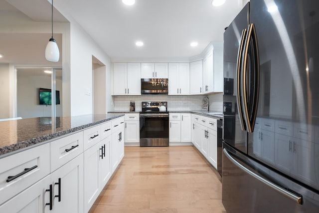 9197 N Rd Unit C, Palos Hills, IL 60465 - kitchen featuring stainless steel appliances, decorative backsplash, dark stone counters, white cabinets, and light wood-style flooring