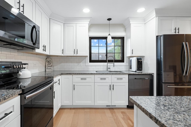 9197 N Rd Unit C, Palos Hills, IL 60465 - kitchen featuring freestanding refrigerator, black electric range oven, dishwashing machine, light wood-style flooring, and white cabinets
