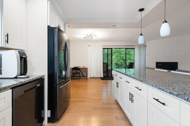 9197 N Rd Unit C, Palos Hills, IL 60465 - kitchen featuring freestanding refrigerator, light wood finished floors, white cabinetry, and hanging light fixtures