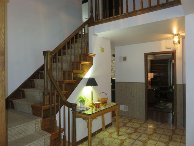 8025 Shoshone Trl, Tinley Park, IL 60477 - stairs with a high ceiling, tile patterned floors, and a wainscoted wall