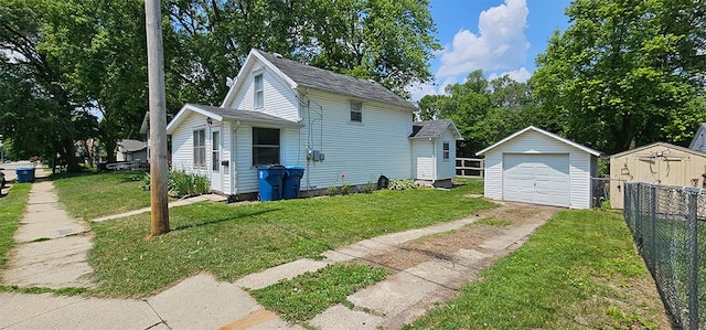 909 W 6th St, Dixon, IL 61021 - view of front of home with concrete driveway, an outdoor structure, and a detached garage