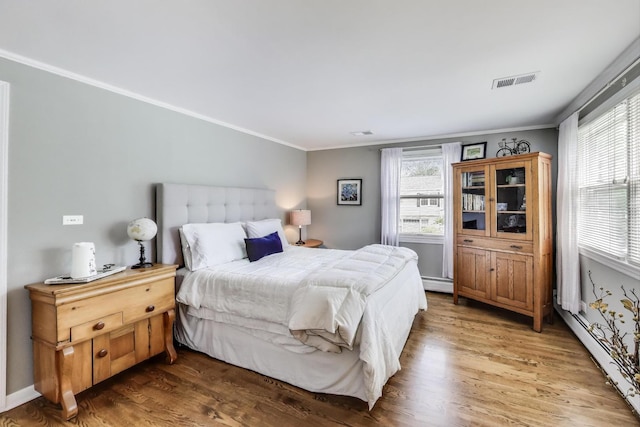 1311 E Woodford Pl, Arlington Heights, IL 60004 - bedroom featuring a baseboard heating unit, ornamental molding, and wood finished floors