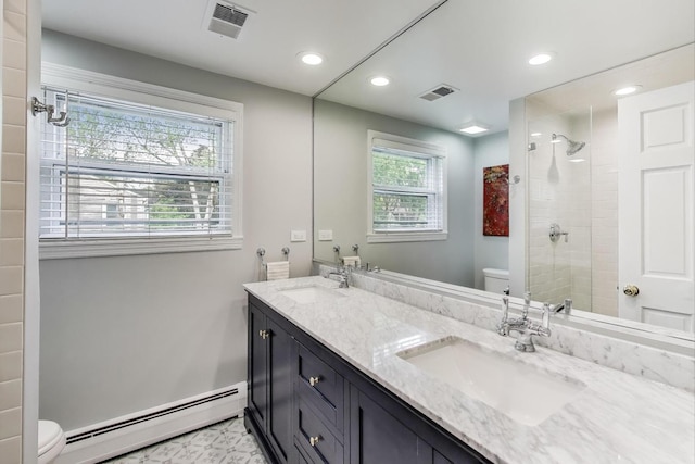 1311 E Woodford Pl, Arlington Heights, IL 60004 - bathroom with baseboard heating, double vanity, a tile shower, and recessed lighting