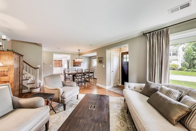 1311 E Woodford Pl, Arlington Heights, IL 60004 - living room with light wood-style floors, stairway, and ornamental molding