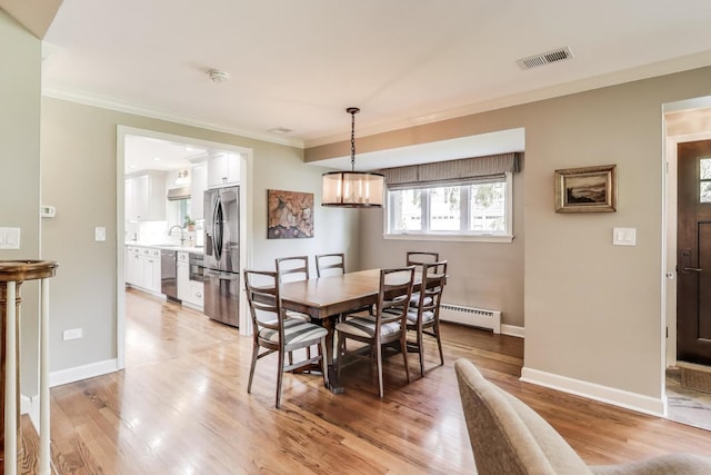 1311 E Woodford Pl, Arlington Heights, IL 60004 - dining space with ornamental molding, light wood-style flooring, baseboard heating, and a chandelier