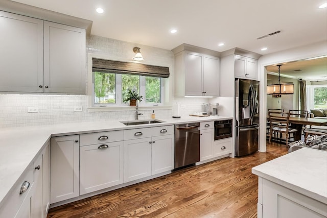 1311 E Woodford Pl, Arlington Heights, IL 60004 - kitchen featuring dishwasher, black refrigerator with ice dispenser, backsplash, light wood finished floors, and light countertops