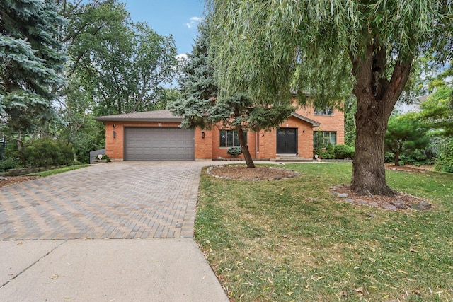 318 10th St, Wheeling, IL 60090 - view of front facade with decorative driveway, a garage, brick siding, and a front yard