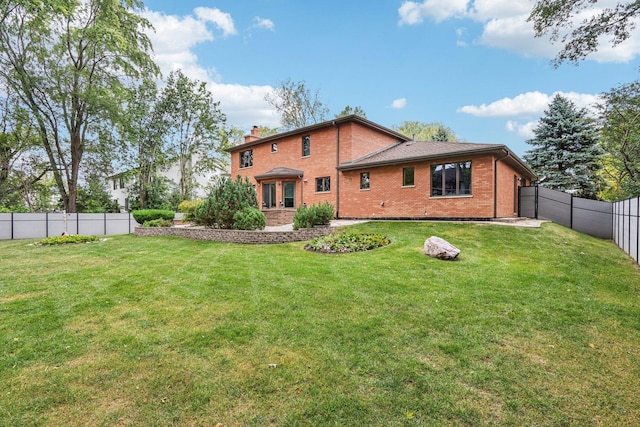 318 10th St, Wheeling, IL 60090 - back of property with brick siding, a chimney, a fenced backyard, and french doors