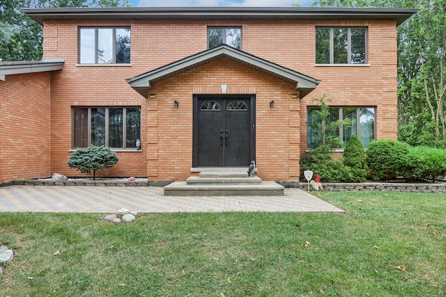 318 10th St, Wheeling, IL 60090 - view of front of property with brick siding, a front lawn, and entry steps