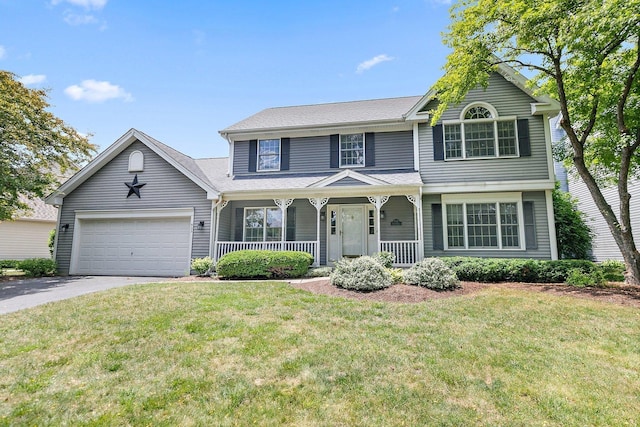 905 Pember Cir, West Dundee, IL 60118 - view of front of house with a porch, driveway, an attached garage, and a front lawn