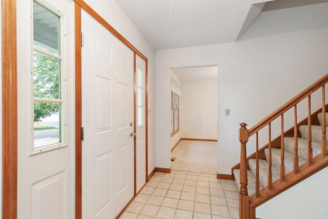 905 Pember Cir, West Dundee, IL 60118 - entryway with stairway, light tile patterned floors, and light carpet