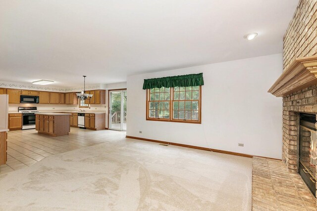 905 Pember Cir, West Dundee, IL 60118 - unfurnished living room featuring a fireplace and light carpet