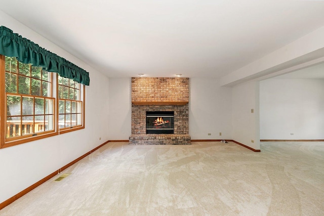 905 Pember Cir, West Dundee, IL 60118 - unfurnished living room featuring a brick fireplace and carpet