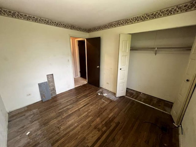 1116 Amherst Ln, University Park, IL 60484 - unfurnished bedroom with dark wood-style flooring and a closet