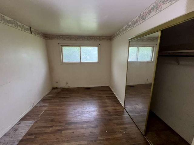 1116 Amherst Ln, University Park, IL 60484 - unfurnished bedroom featuring multiple windows, a closet, and wood finished floors